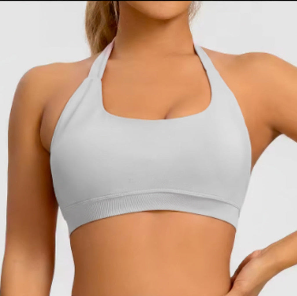 Light gray sports bra worn by a person on a plain background